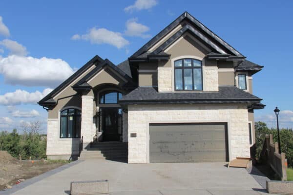 Sandy toned stone and stucco work on a South West Edmonton home by Met Exteriors.