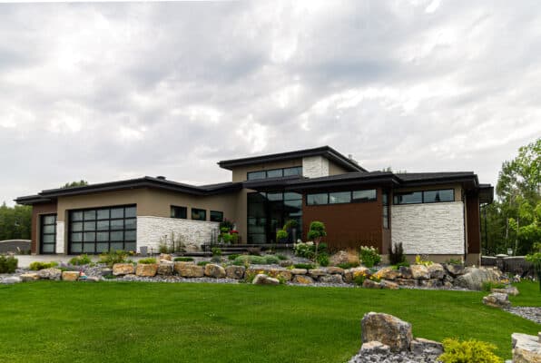 Large home in Edmonton with a stone and stucco exterior crafted by met Exteriors.