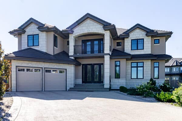 Large executive residential property in Edmonton's Windemere area with stone and stucco by Met Exteriors.