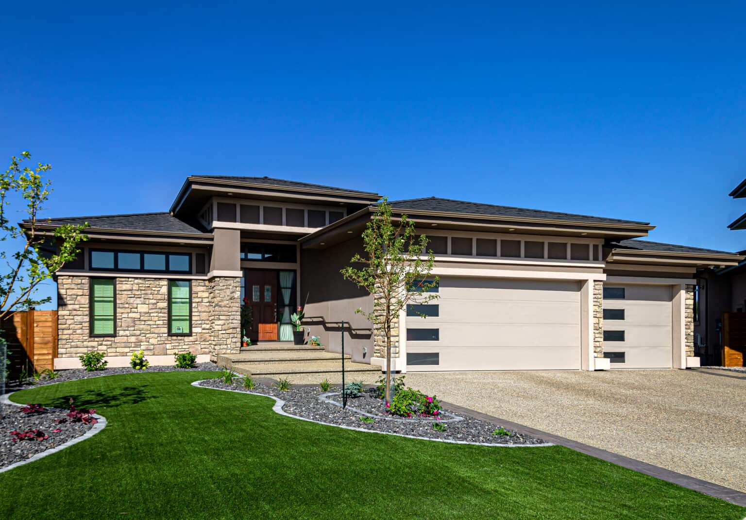 Stone and stucco by Met Exteriors on a home in Edmonton's Widemere area.